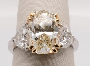 LADIES PLATINUM & 18K YG RING 5.01CT OVAL VS2.K WITH 2.52CTW HEARTS