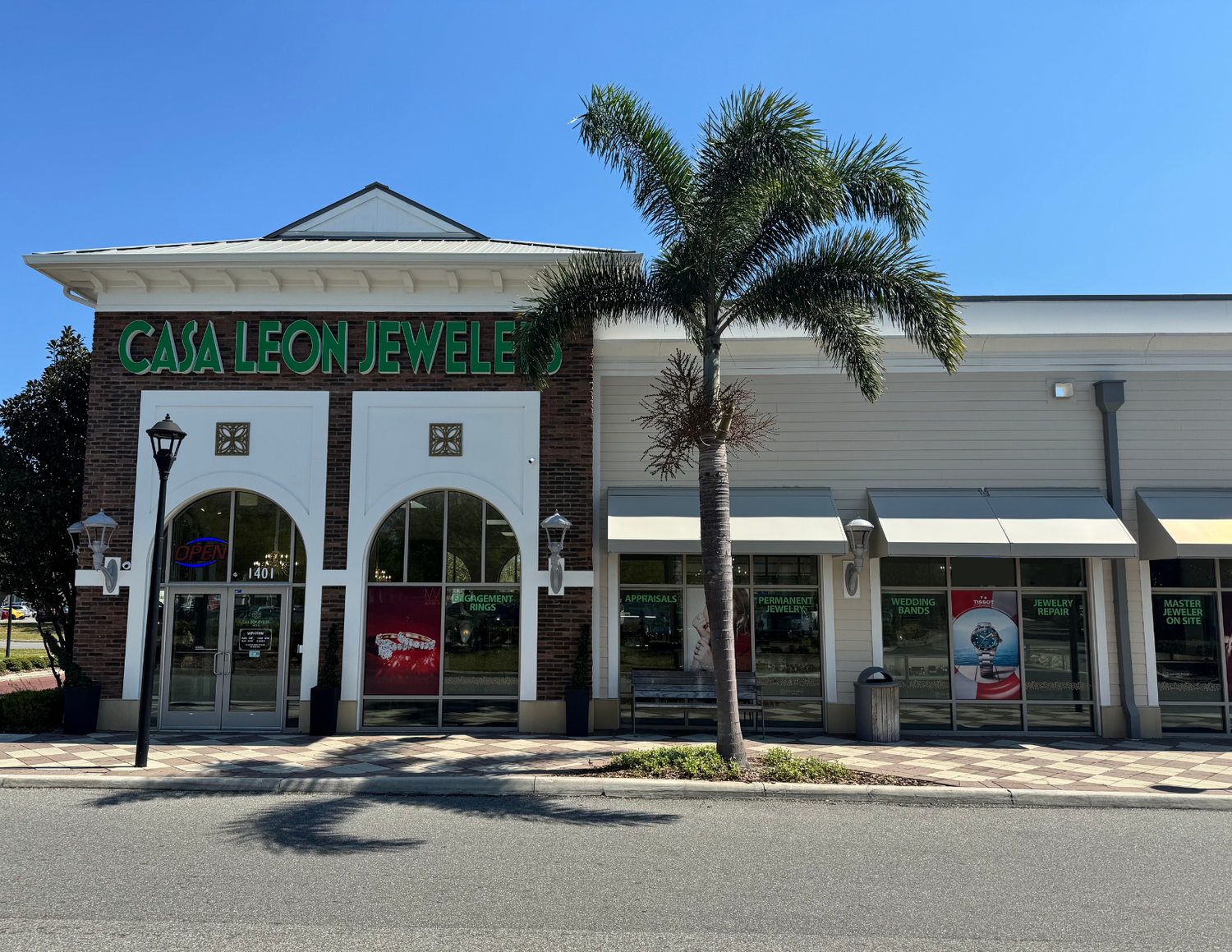 Casa Leon Jeweler store front with palm tree on a clear day
