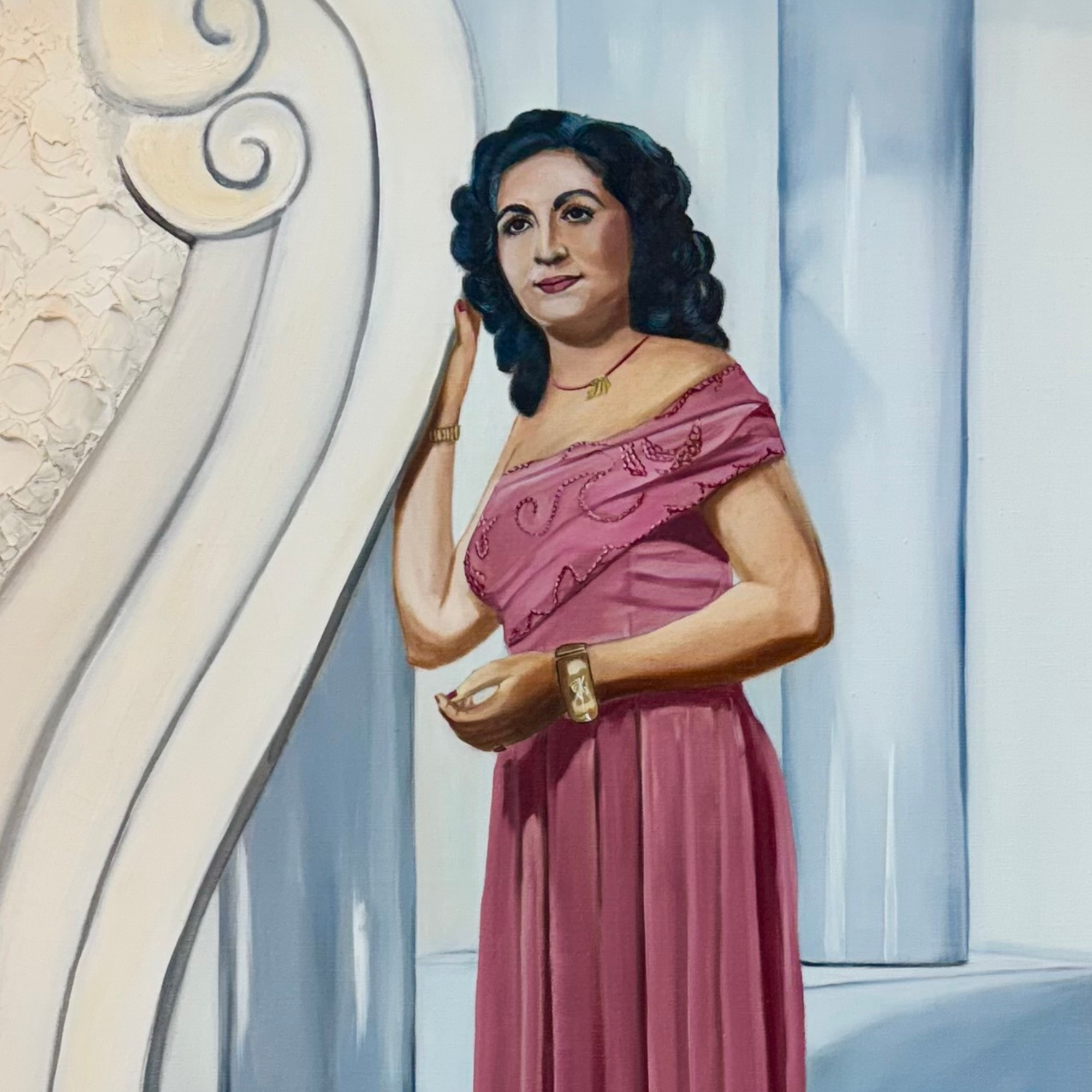Woman in a pink dress standing in a decorative interior setting